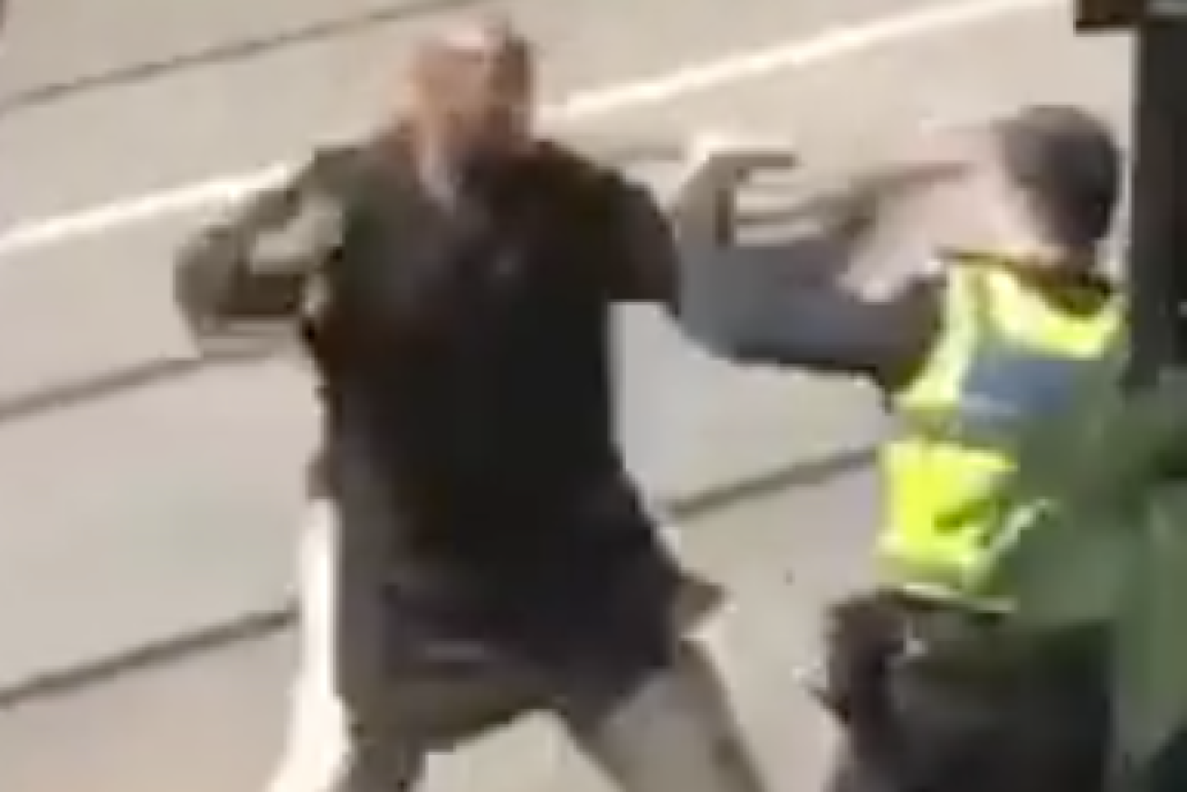 Hassan Khalif Shire Ali  attacking police on Bourke Street. 