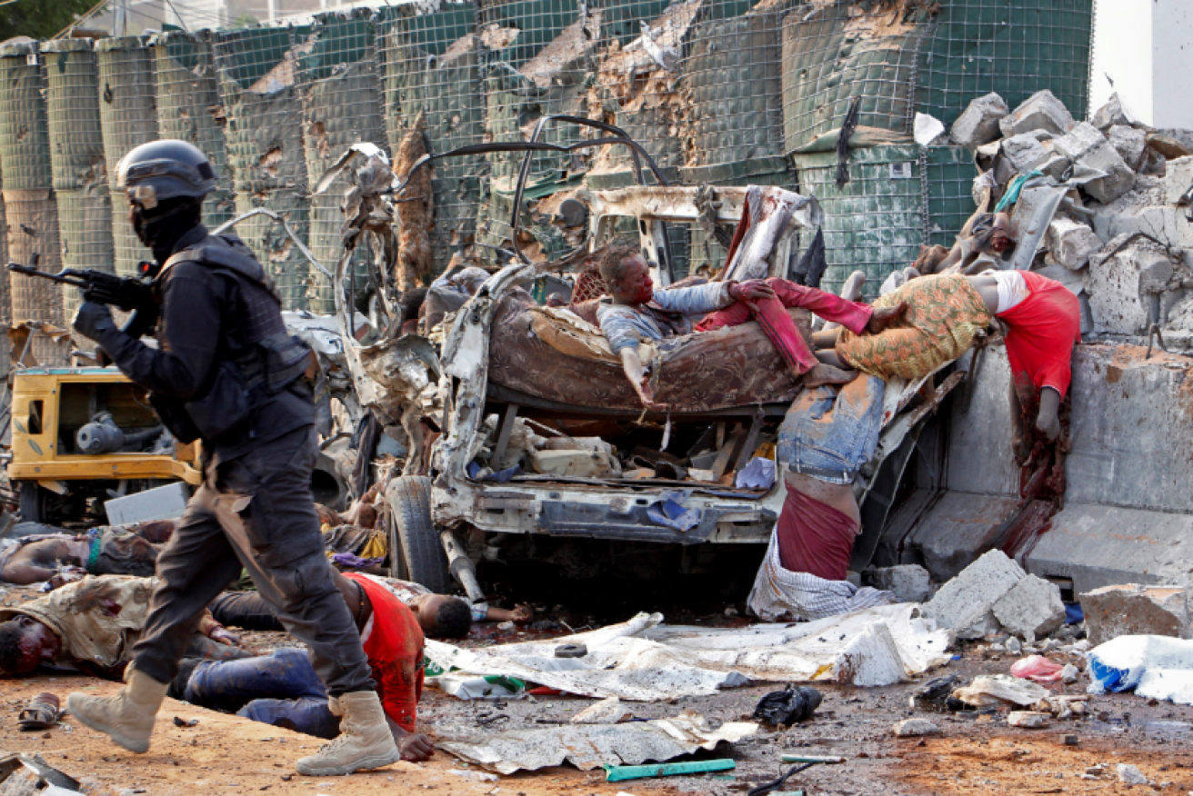 Broken bodies litter the rubble of the Sahafi Hotel in Mogadishu.