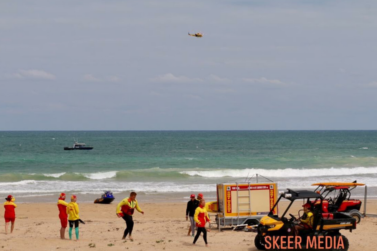 Lifesavers make sure swimmers are out of the water at Pyramids Beach.