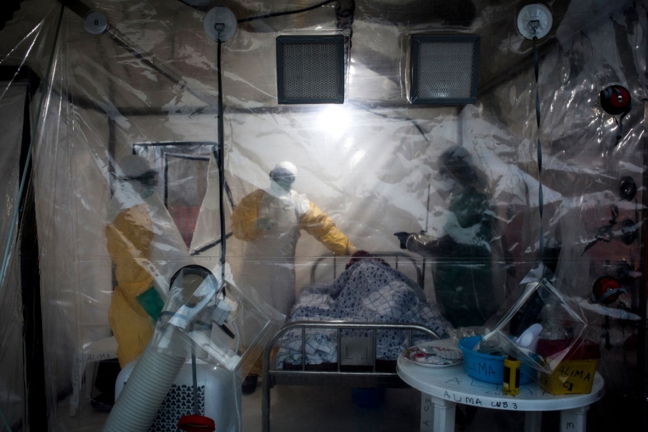Medical workers check on a patient with ebola at  Beni in August. 