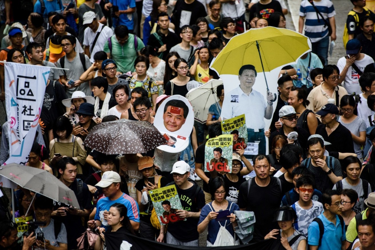 Protesters march on July 1, 2017 to remember the 2014 Umbrella Movement in Hong Kong. 