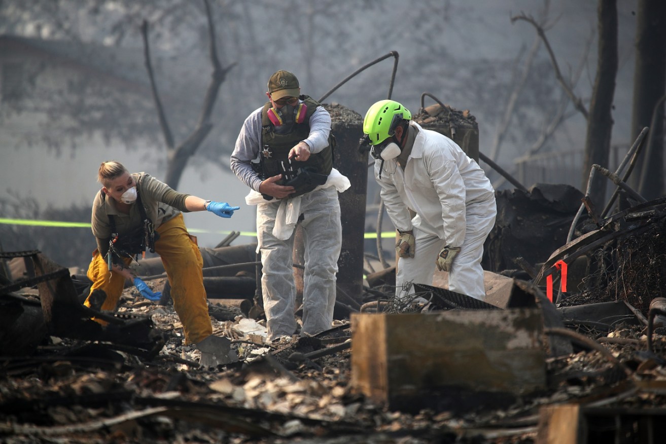 Rescue workers discover suspected human remains in a home destroyed by the Camp Fire on November 16 in Paradise, California. 
