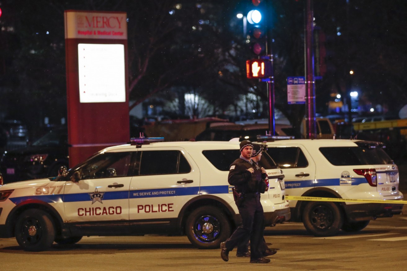 Chicago Police officers monitor the area outside of the Mercy Hospital where a gunman opened fire.  