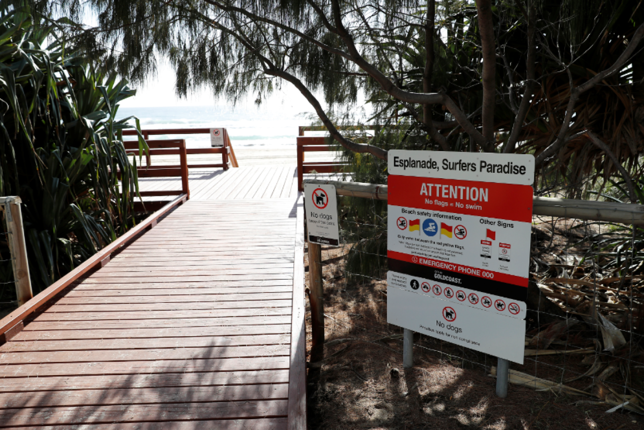Surfers Paradise bathers found the infant's body washed up on the beach.