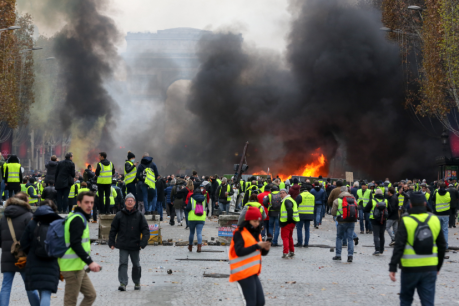 French President Emmanuel Macron surrenders to protesters and scraps controversial fuel tax hike