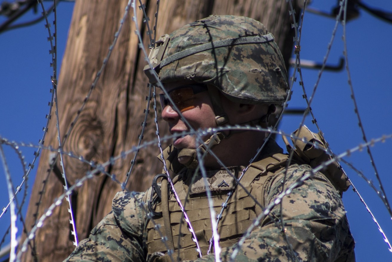 US Army soldiers fortify the US-Mexico border wall with barbed wire at Mexicali in Mexico. 