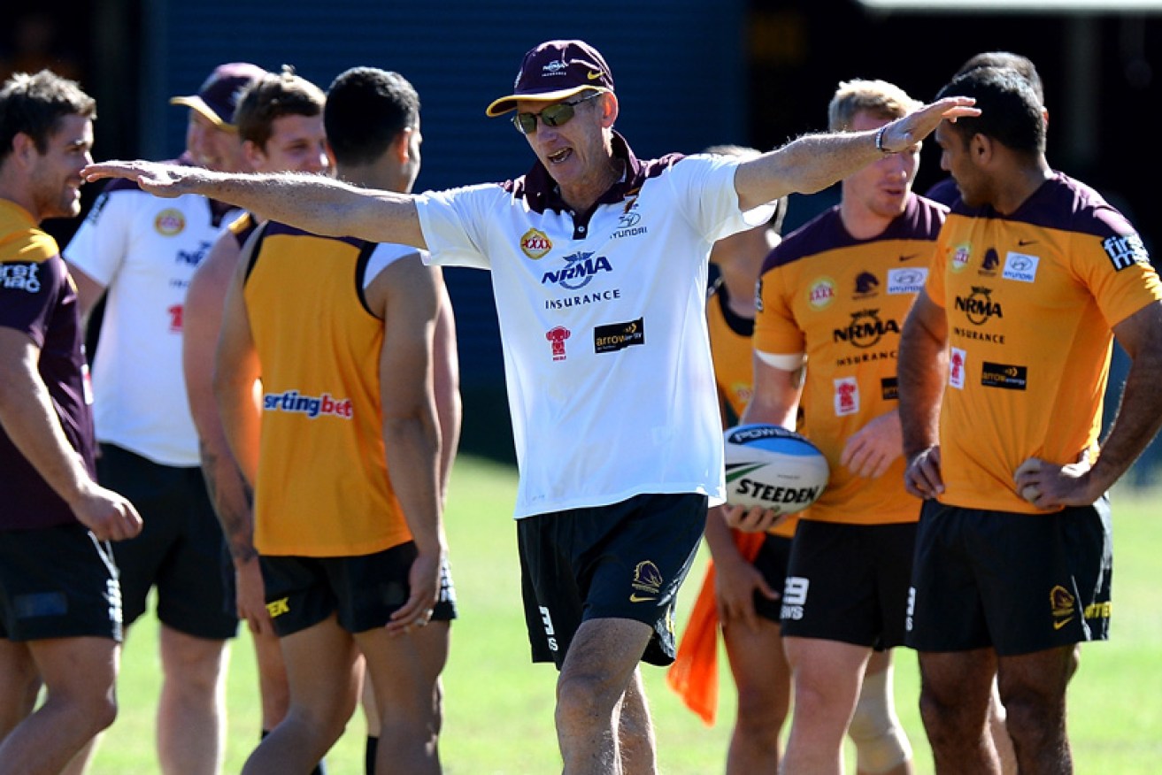 Coach Wayne Bennett enjoys a lighter moment with his Brisbane players in September 2015. 
