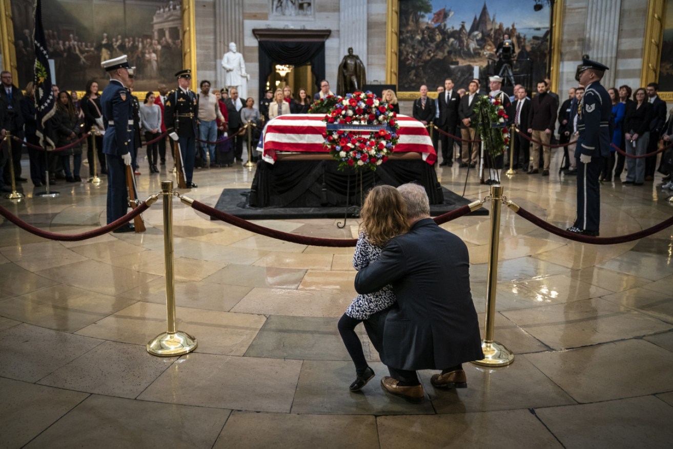 Mourners pay their respects at the casket of the late former President George H.W. Bush.