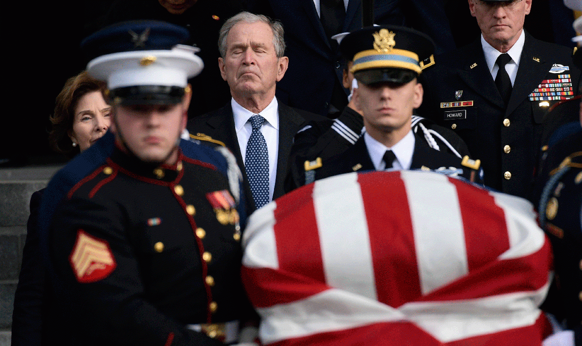 George W Bush fought back tears during the moving service to his father George H W Bush in December.