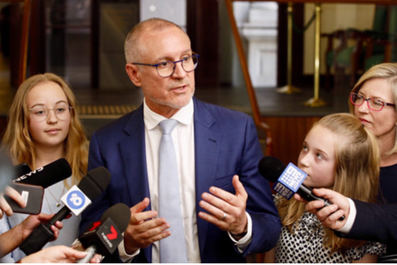 Former SA premier Jay Weatherill gathers his children around him while announcing his retirement from politics.