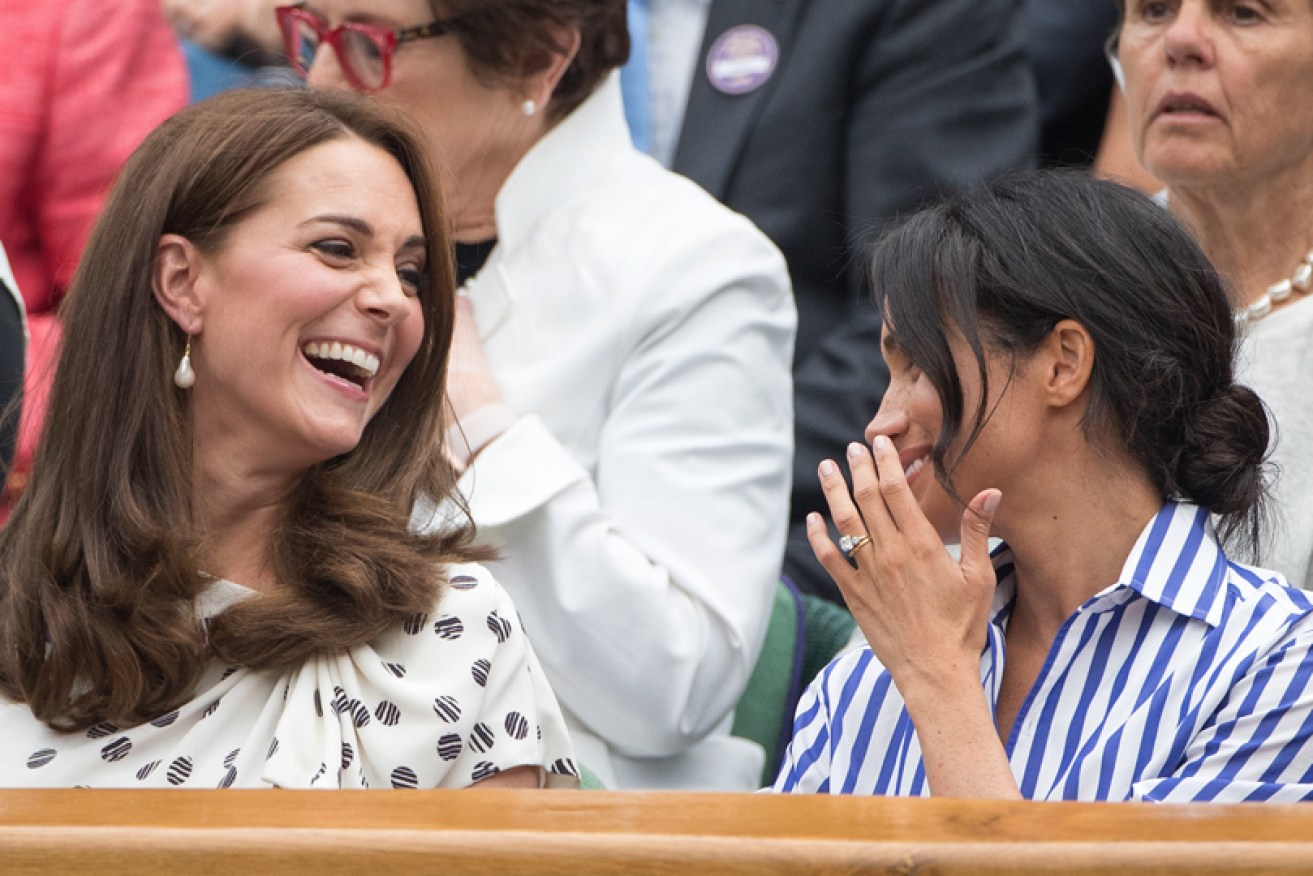 The Duchess of Sussex and the Duchess of Cambridge share a laugh at Wimbledon on July 14.