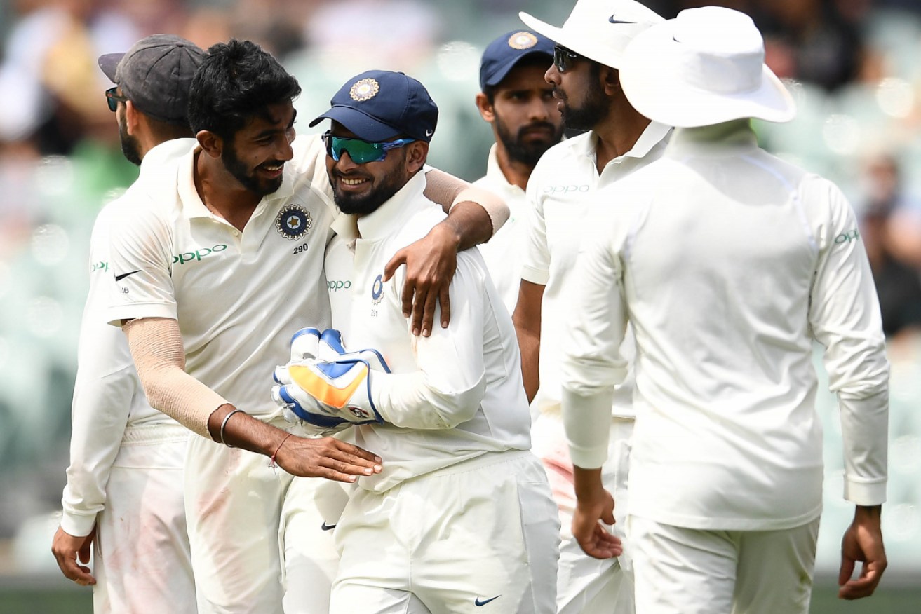 Indian paceman Jasprit Bumrah congratulates Rishabh Pant on day five of the First Test at Adelaide Oval on Monday. 