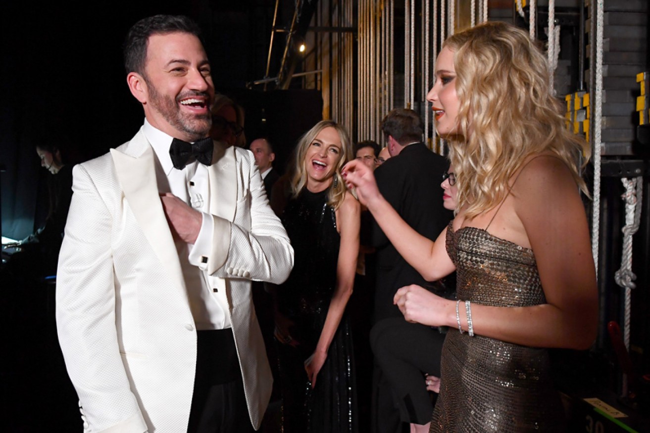 2018 Oscars host Jimmy Kimmel has a laugh with star Jennifer Lawrence backstage.