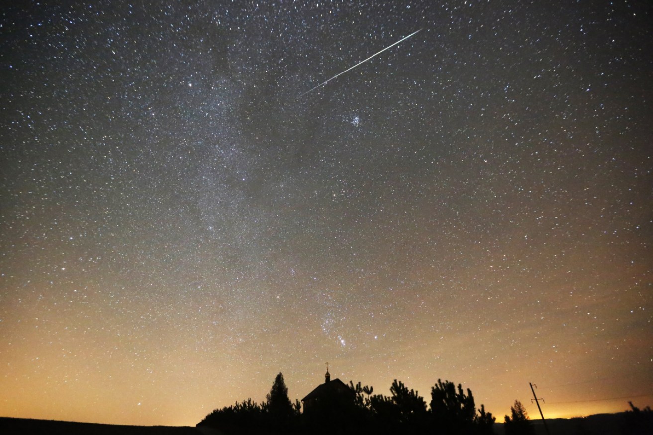 A meteor from the 2017 Geminid shower burns up in the sky above Belarus.