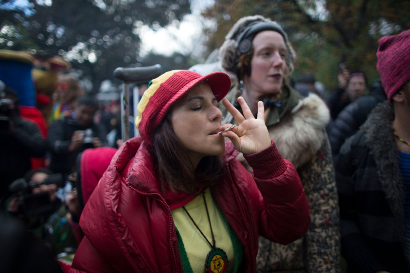A woman smokes marijuana at a legalisation party in Toronto, Canada.