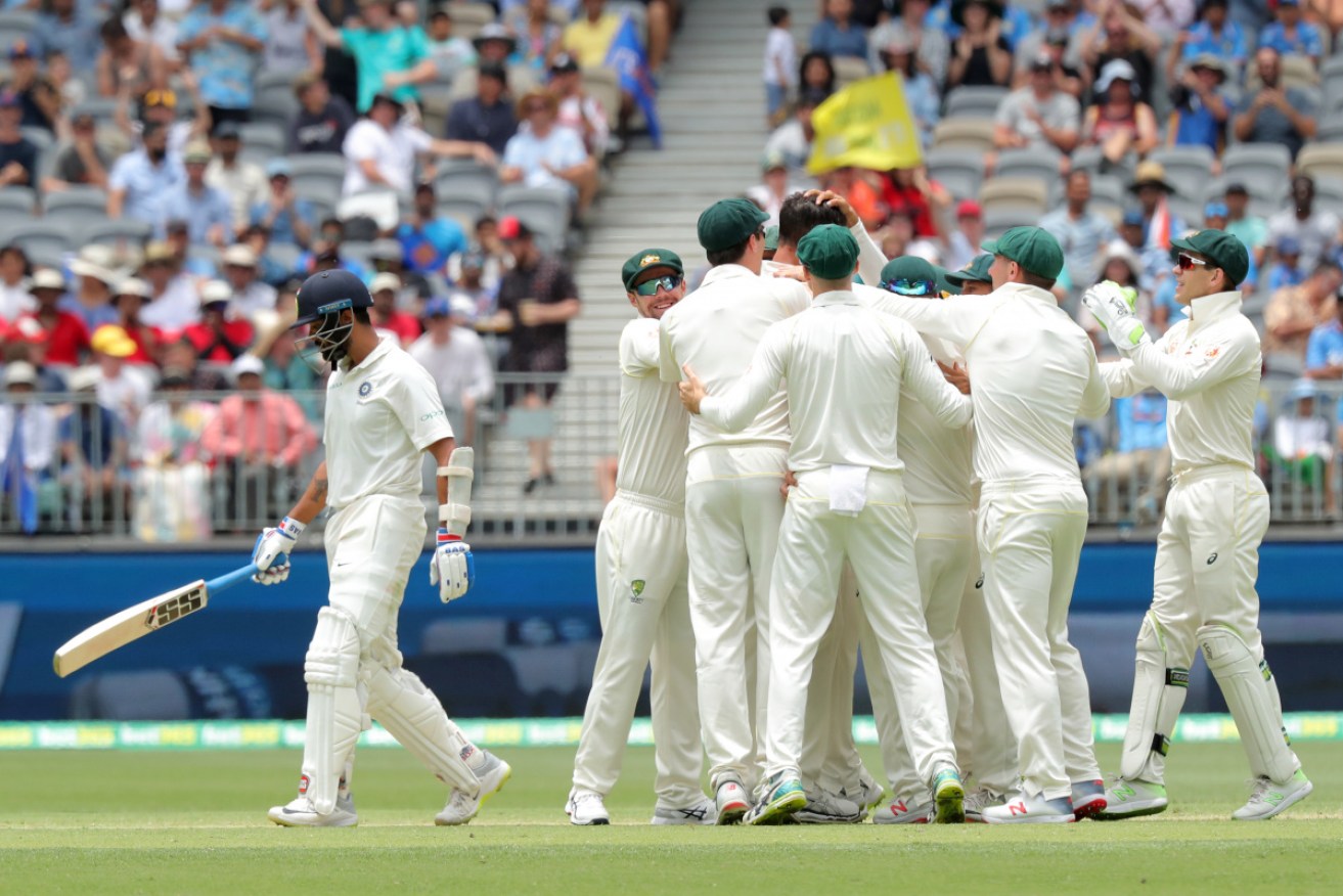 Australia celebrates as a disappointed Murali Vijay leaves the field for a duck. 