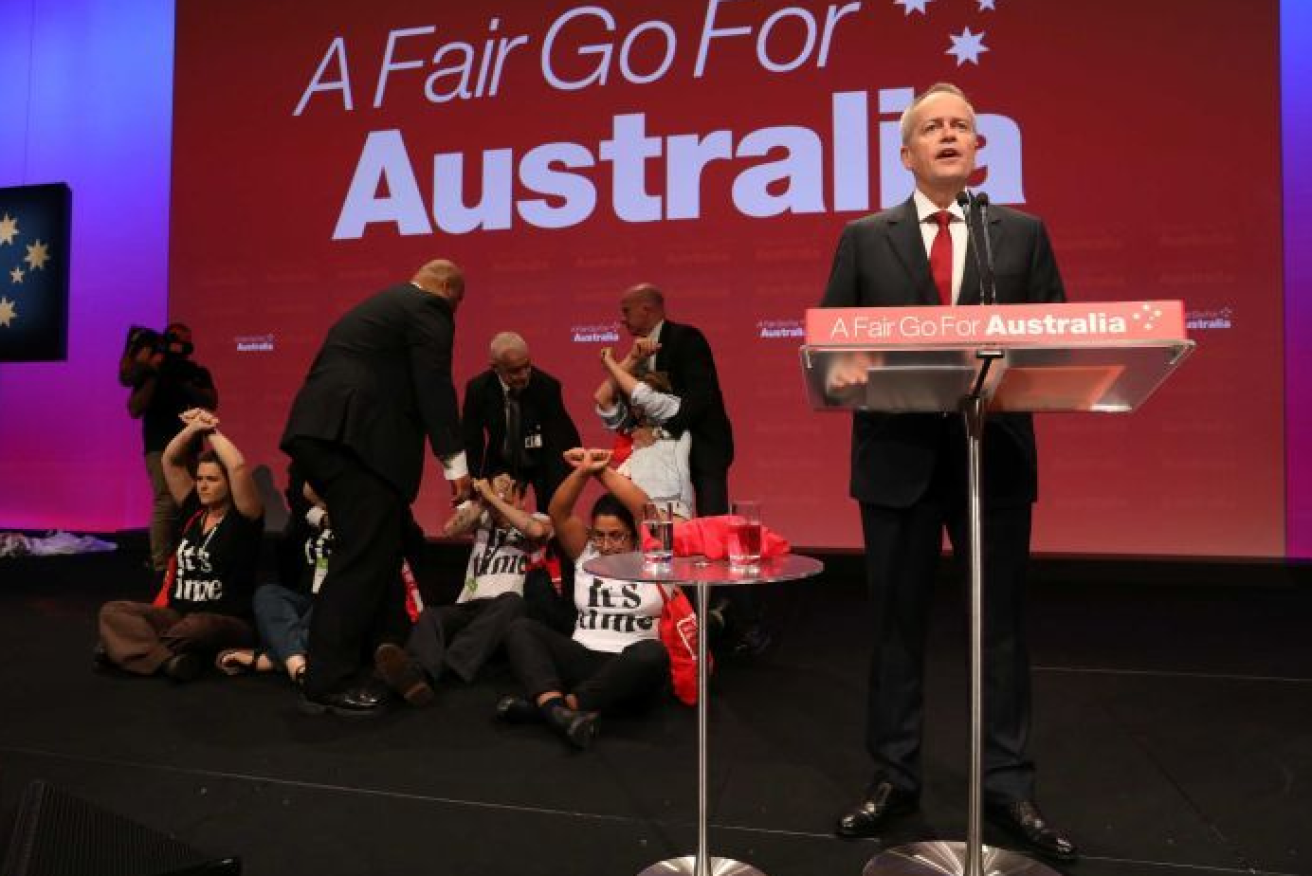 Bill Shorten keeps his cool and sticks to the script as anti-Adani protesters refuse to leave the stage at labor's national conference in Adelaide.