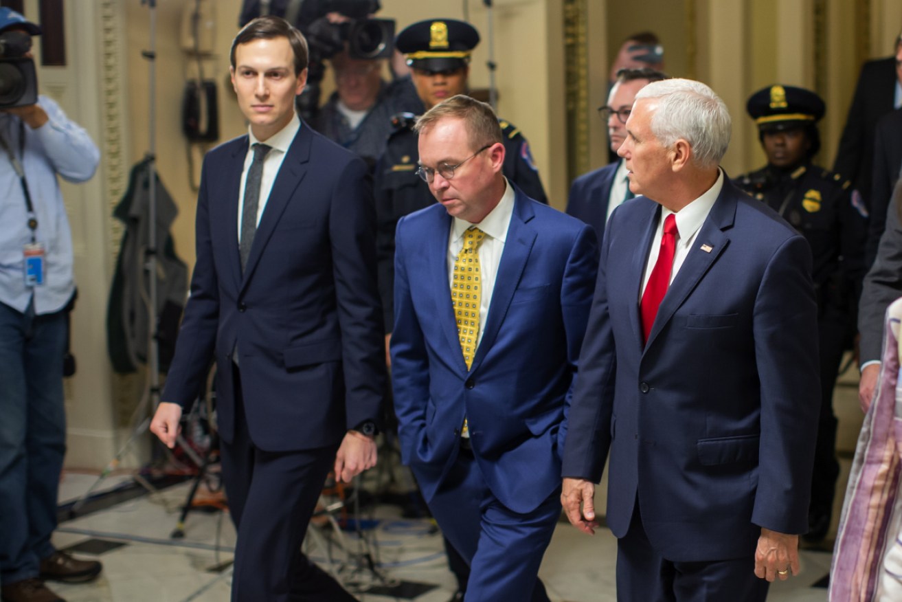 Vice President Mike Pence (R), acting White House Chief of Staff Mick Mulvaney (C) and Jared Kushner (L) walk from the House of Representatives.