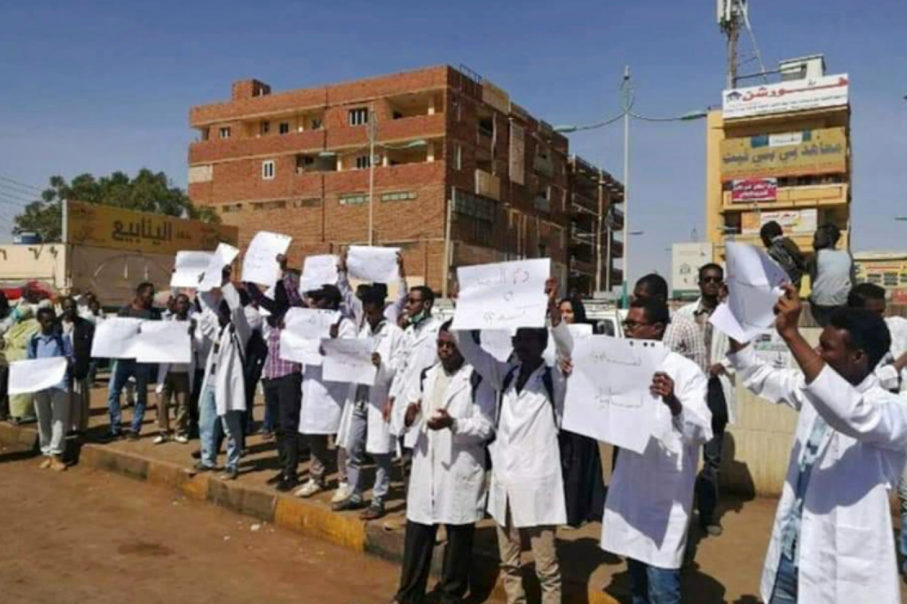 White-coated students at Omdurman  University speak out against the regime before troops used live ammunition