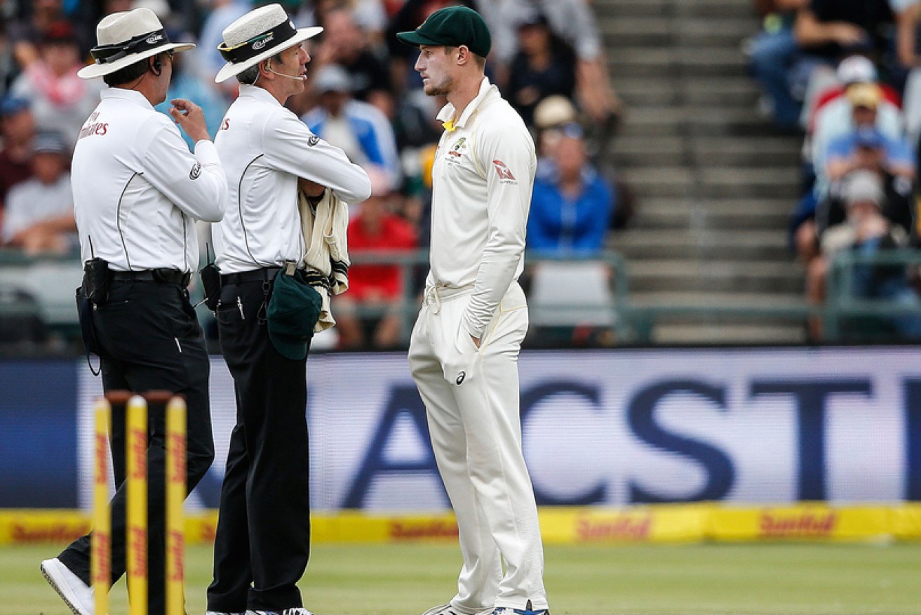 Umpires Richard Illingworth (left) and Nigel Llong question Cameron Bancroft in Cape Town on March 24.