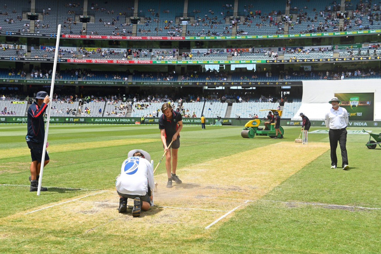 The team at the MCG on a rescue mission to keep the pitch in shape.