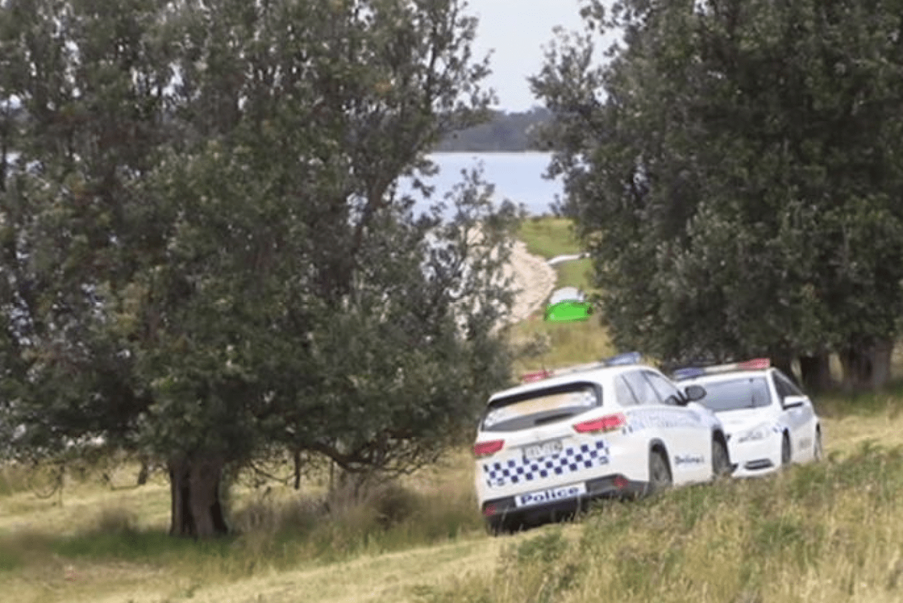 Police vehicles mark the spot where a mother lost her life in Victoria's latest drowning.