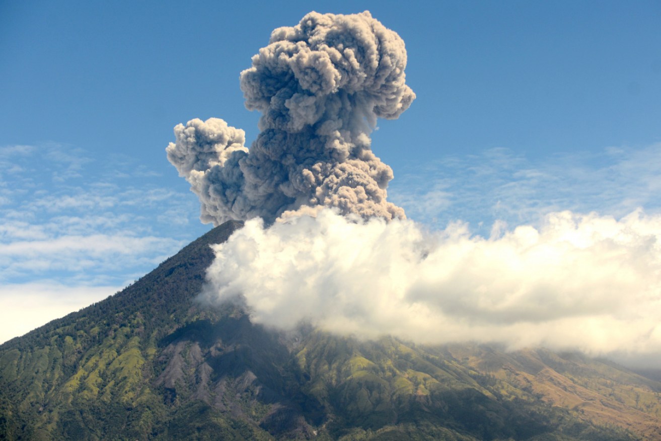 Bali's Mount Agung shoots ash into the air in July.