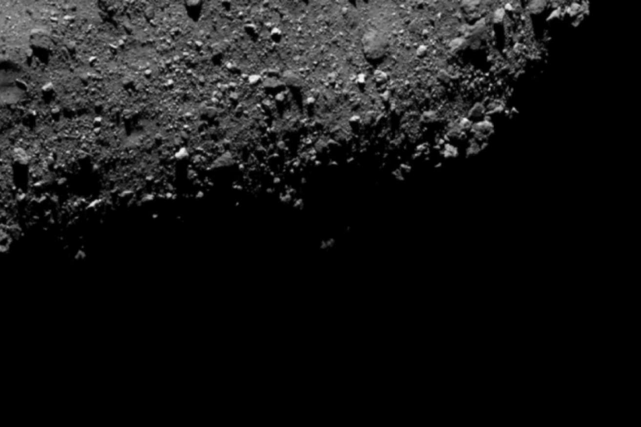 An image of a crater on the asteroid Bennu, 110 million kilometres from Earth. 