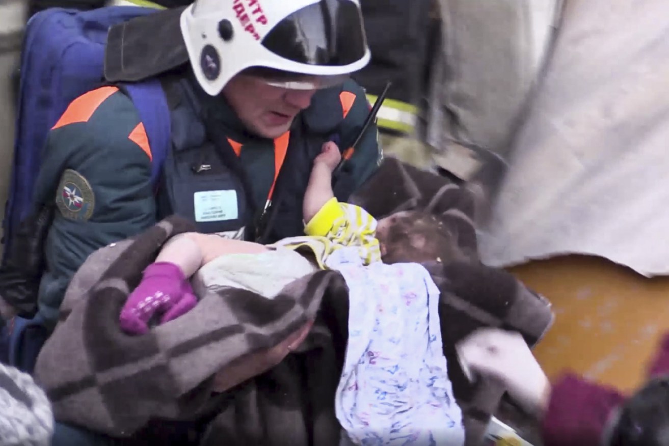 Rescuers heard the 10-month-old boy's cries from inside the rubble.