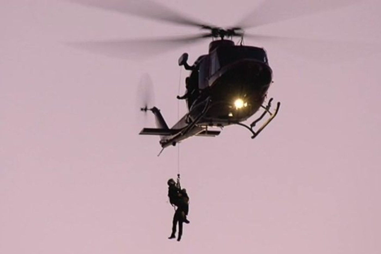 A person is rescued by a helicopter at Second Valley on New Year's Day. 