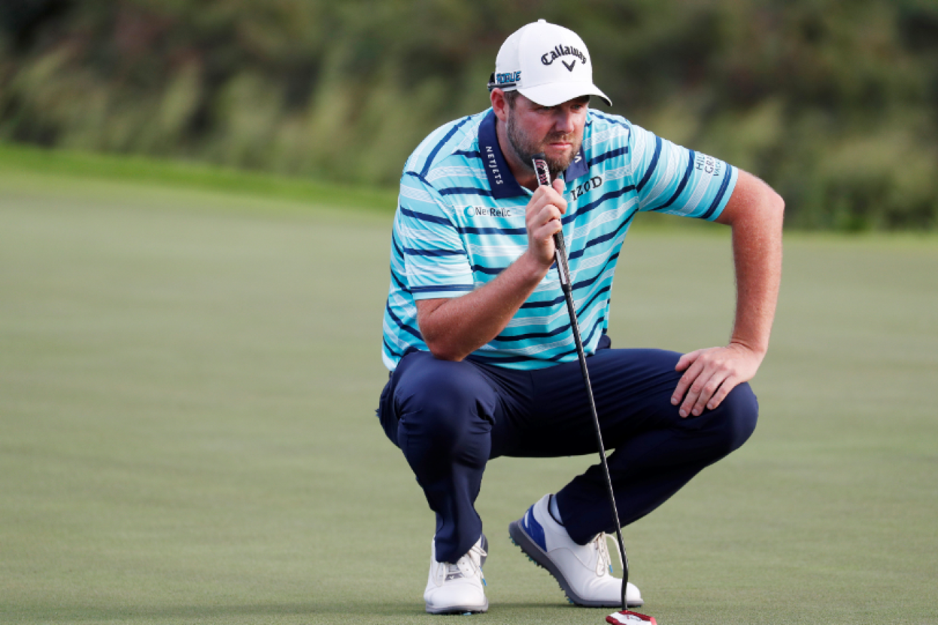 After a triple bogey that would shame a weekend duffer, Marc Leishman reads the green before sinking a vital putt.