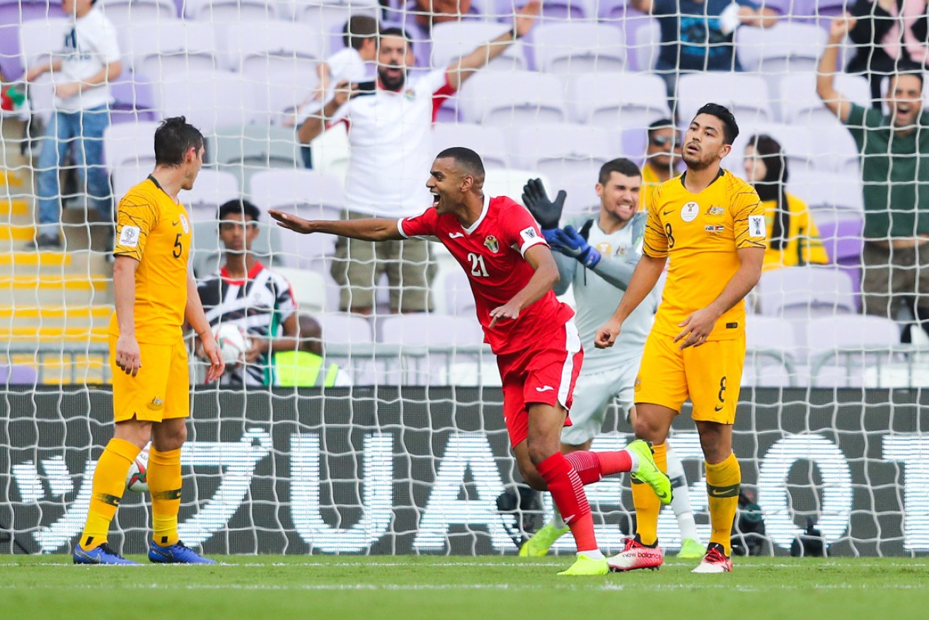 Jordan's Salem Al-Ajalin celebrates Anas Bani Yaseen's headed goal, leaving Massimo Luongo and Mark Milligan in disbelief.  