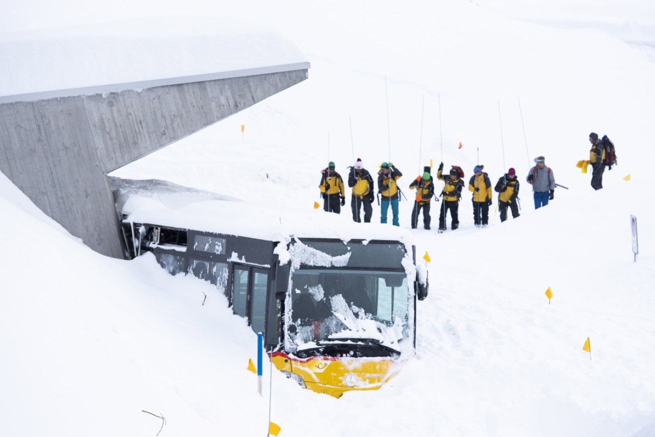 Search and rescue workers on the Schwaegalp in Switzerland after an avalanche hit a hotel, injuring several guests.