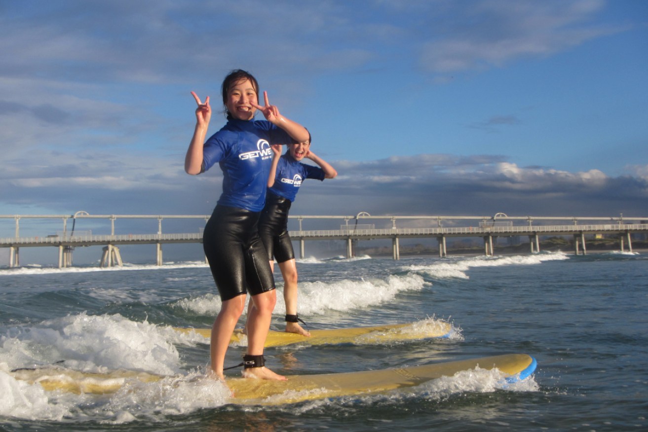 Chinese tourists learn to surf on the Gold Coast.