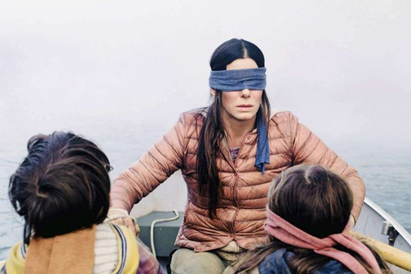 Sandra Bullock hides her eyes from monsters in Netflix's hit <i>Bird Box</i>.