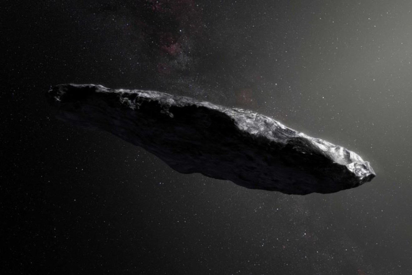 An artist's impression shows the cigar-shaped profile of 'Oumuamua'.

