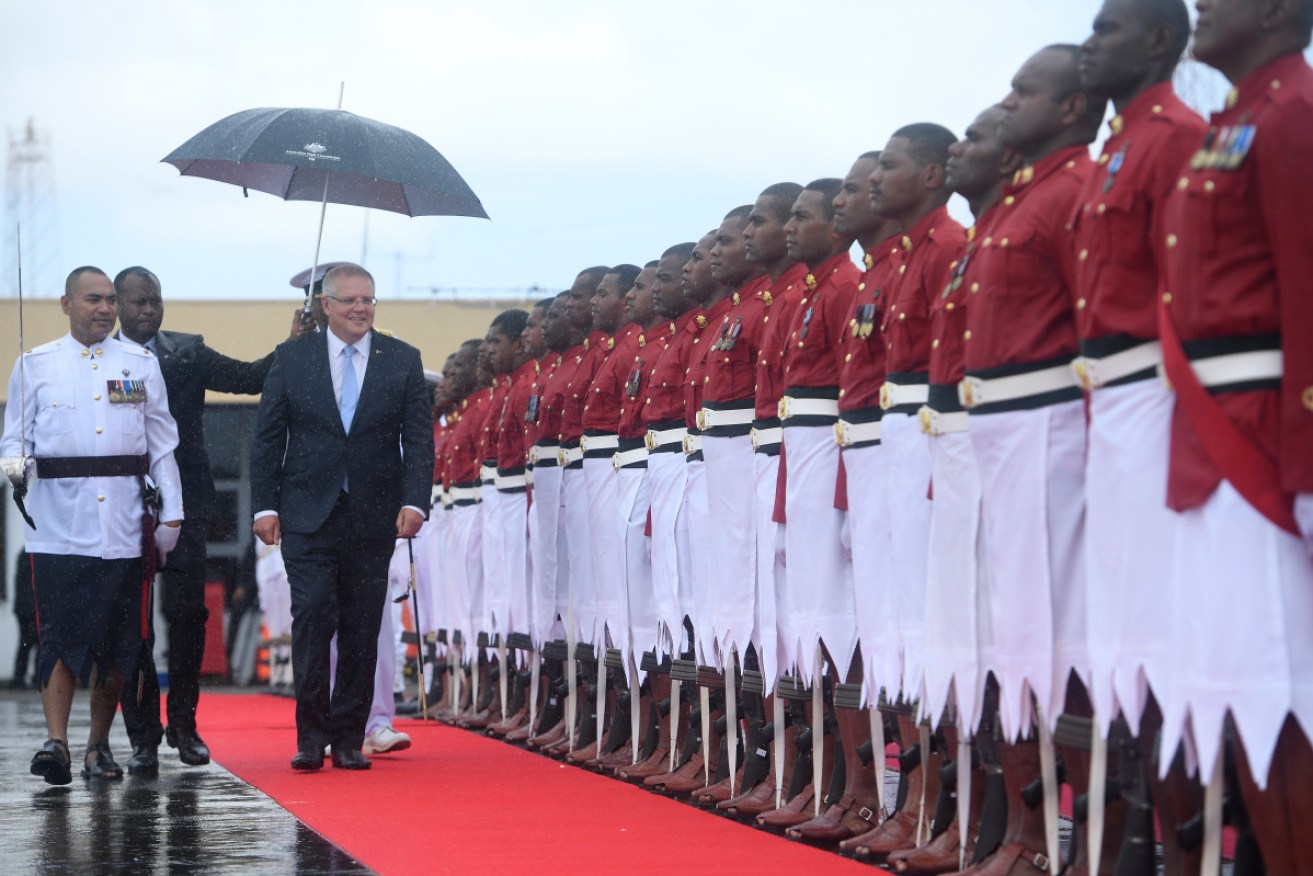 Scott Morrison inspects a Fiji honor guard upon arrival at Suva. 