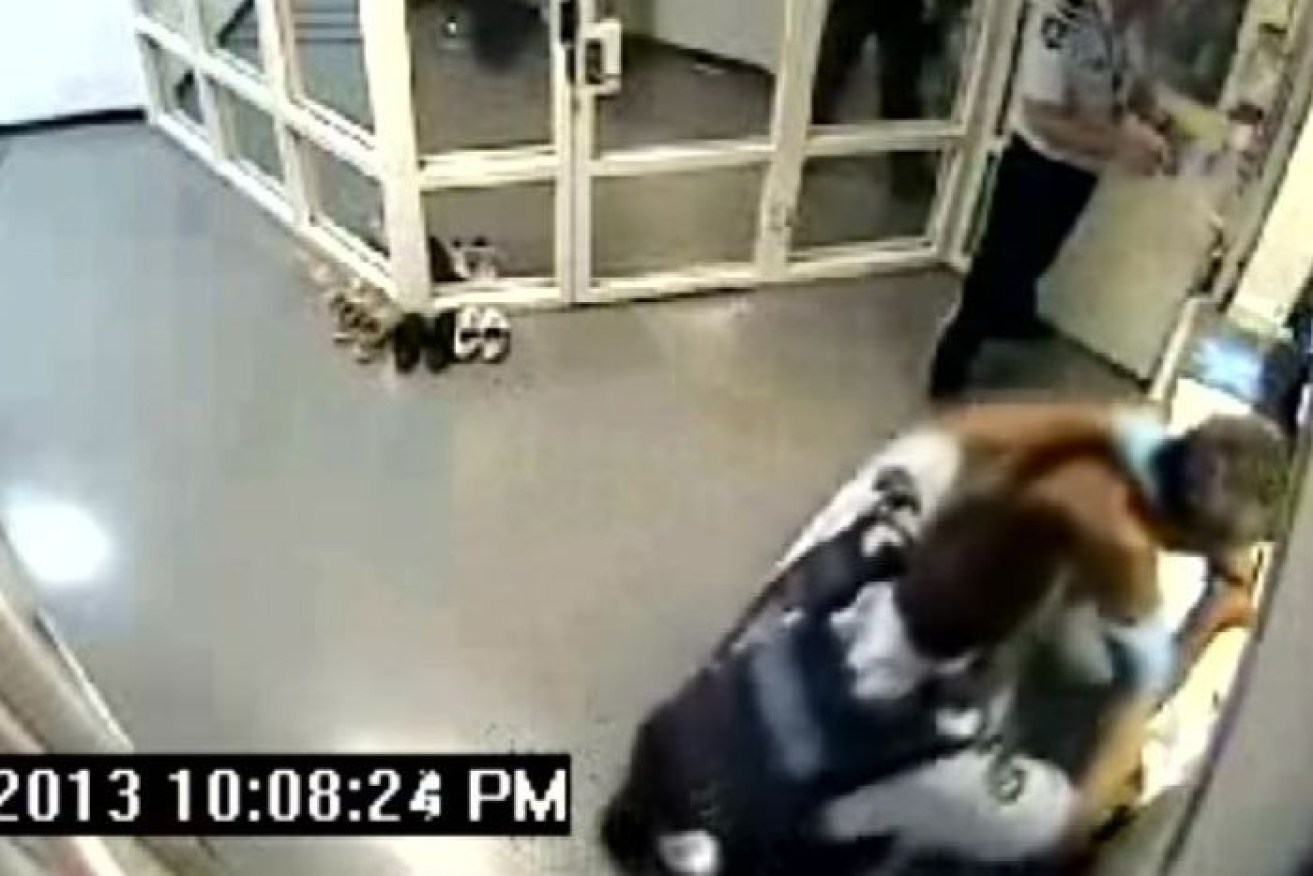 An image from the CCTV footage shows police officer Michael Cooke assaulting Phil Dickson.