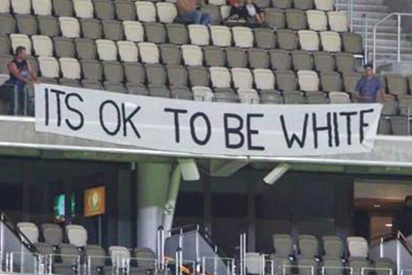 Three men were escorted out of Perth Stadium by security after unveiling the banner.