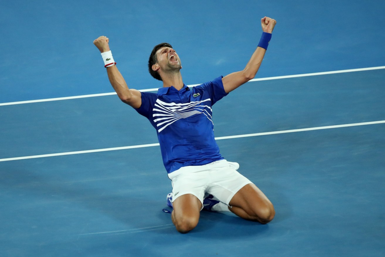Novak Djokovic sinks to his knees after securing his seventh Australian Open singles title on Sunday night. 