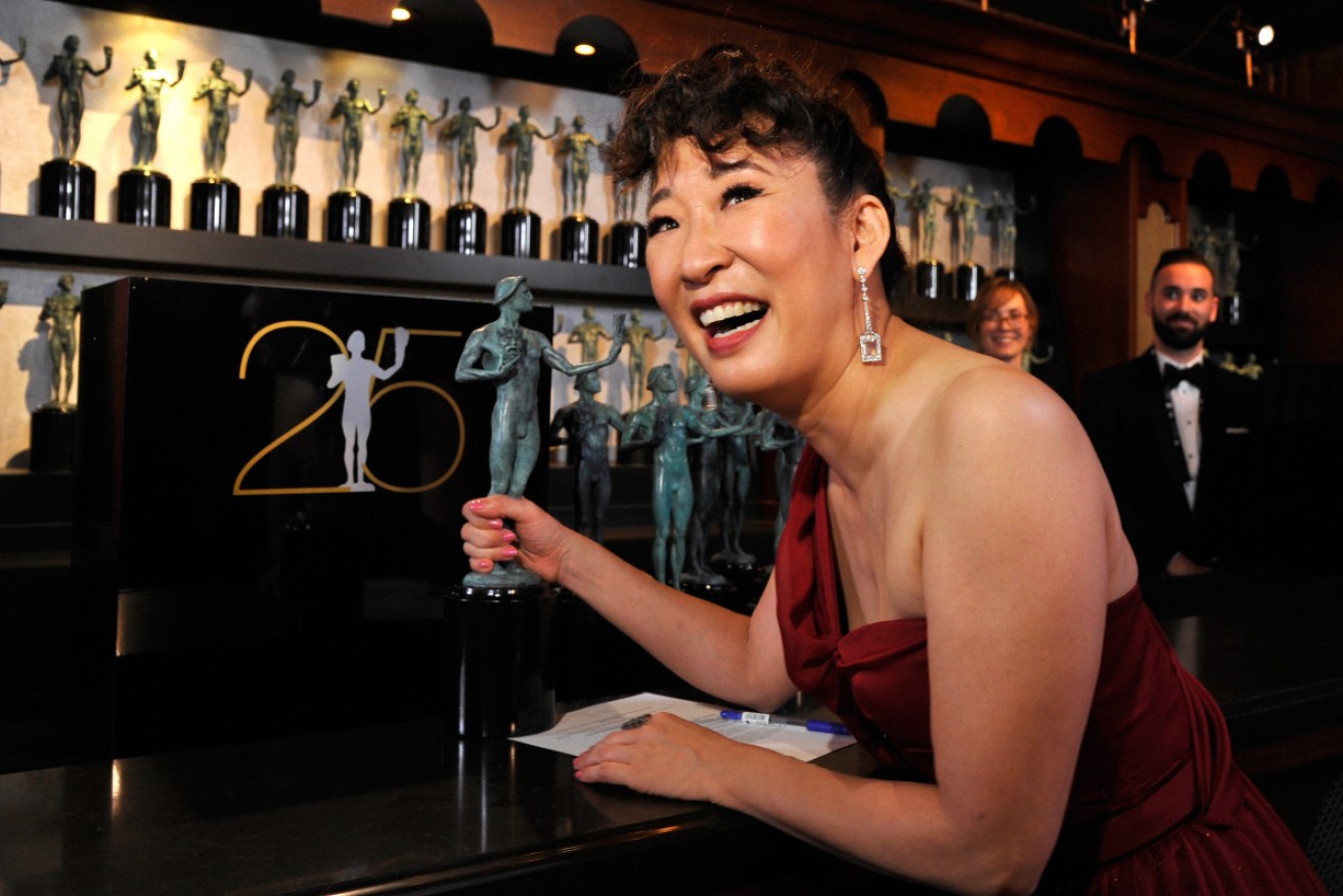 Sandra Oh heads to the bar with her SAG award.