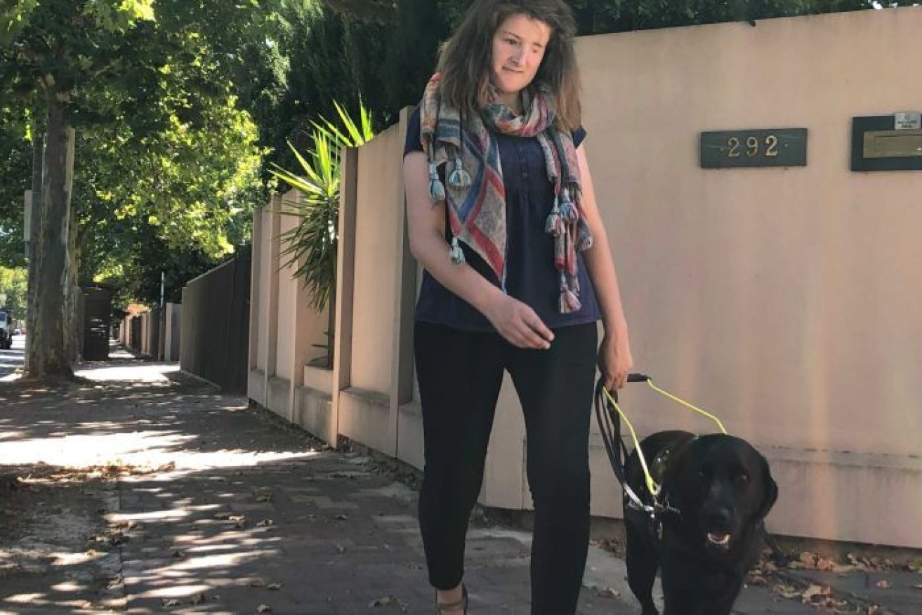 Ellen Fraser-Barbour walks with her guide dog in Adelaide.  