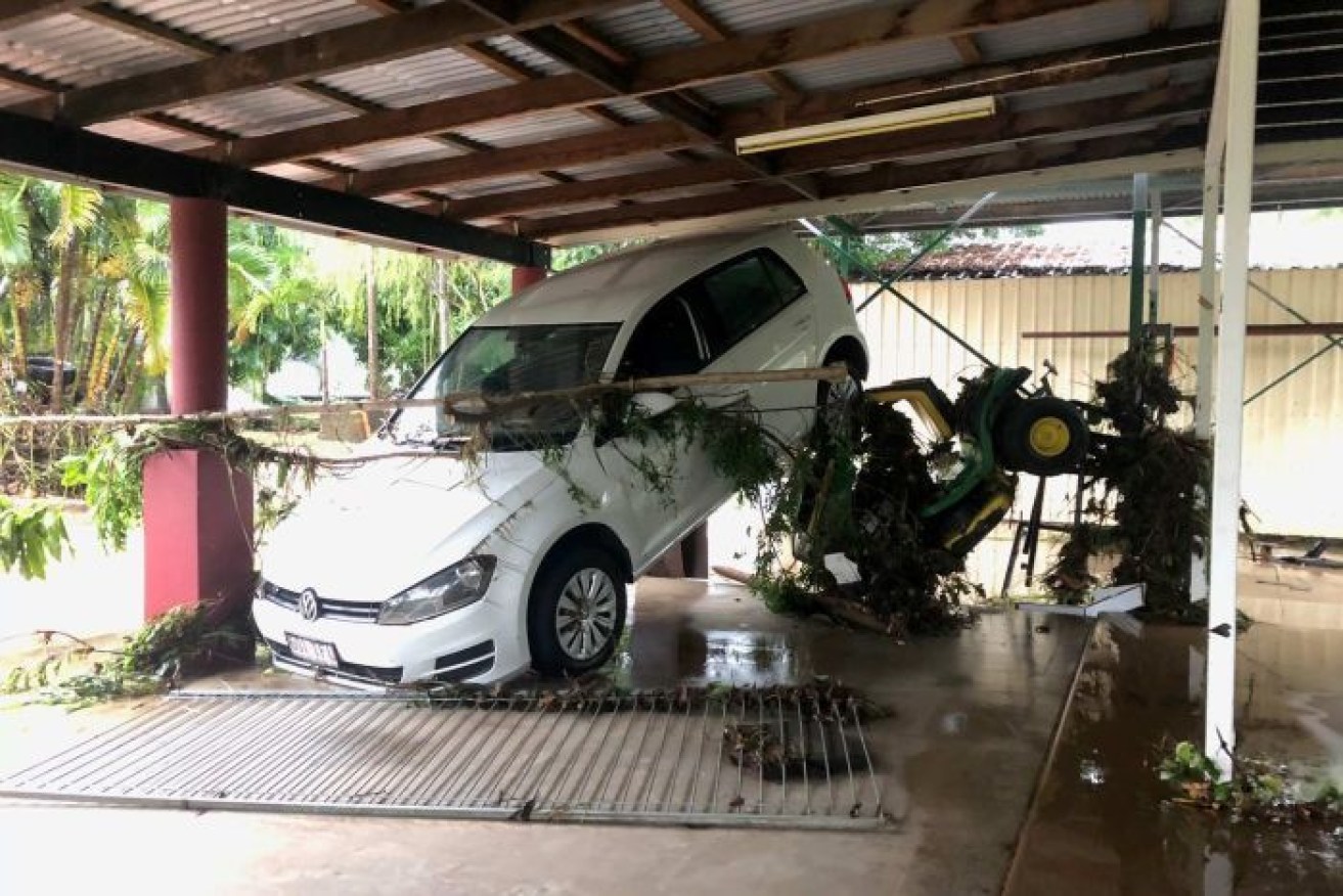 A car was picked up by floodwaters at this house near Townsville.