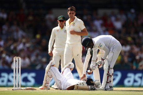 Sri Lankans rocked by Cummins bouncer as Australia dominates in Canberra