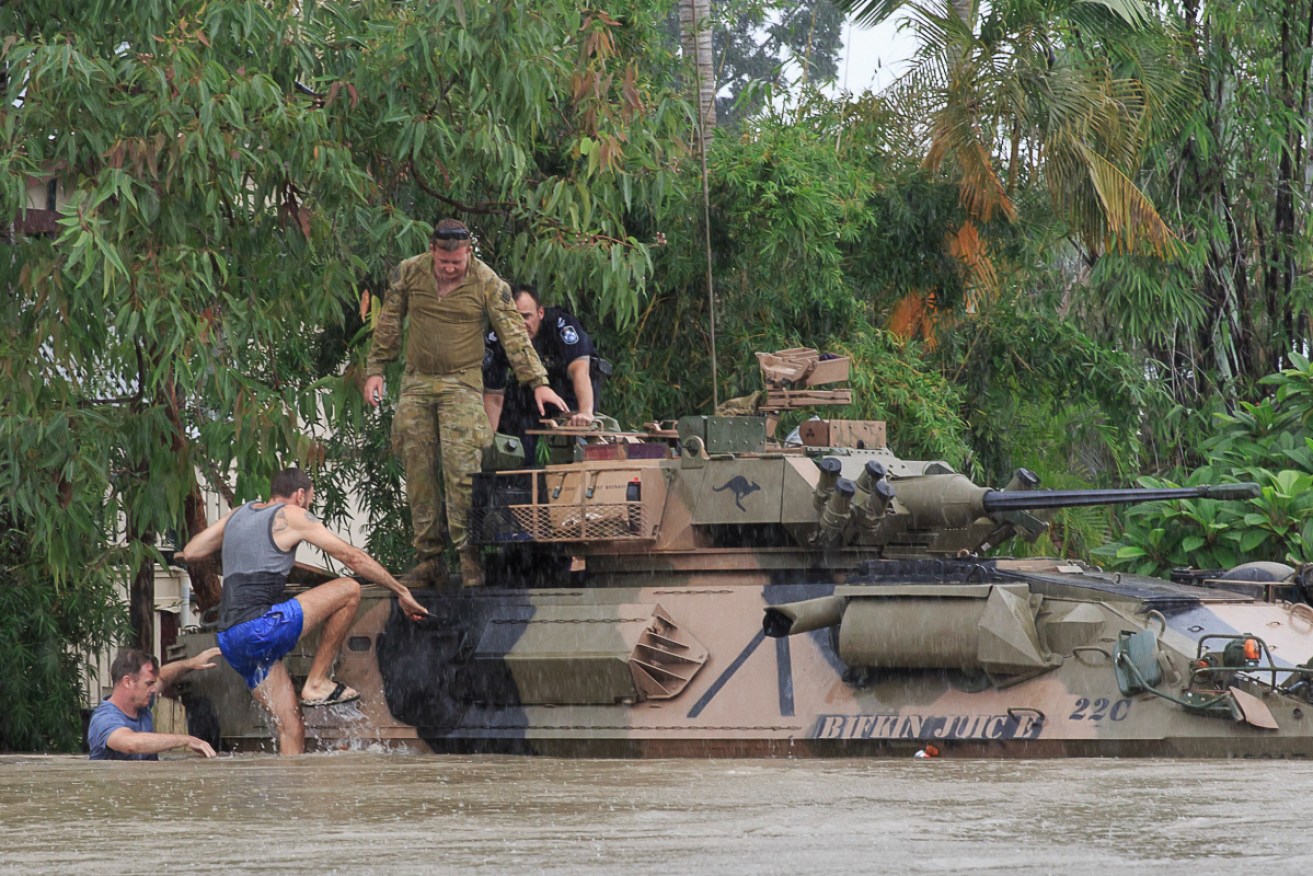 Townsville residents are rescued from the flooded suburb of Hermit Park.