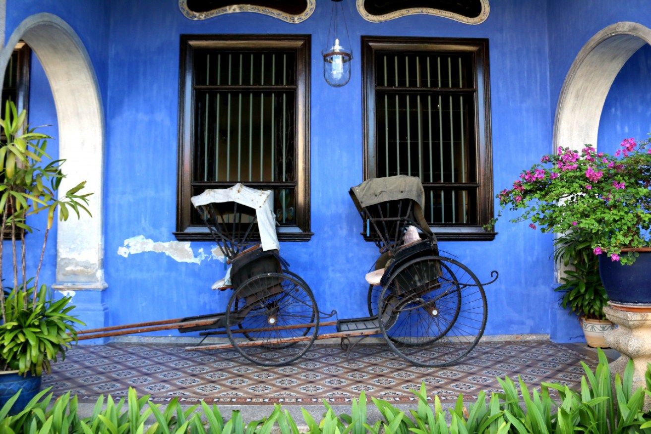 Rickshaws outside a George Town house.