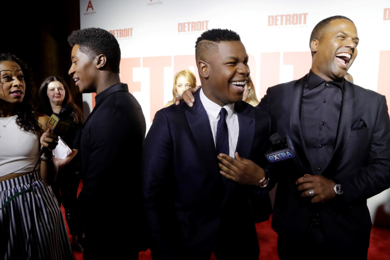 <i>Extra</i>'s  AJ Calloway (r) was all chuckles with actor John Boyega at a 2017 premiere, but he's certainly not laughing now.