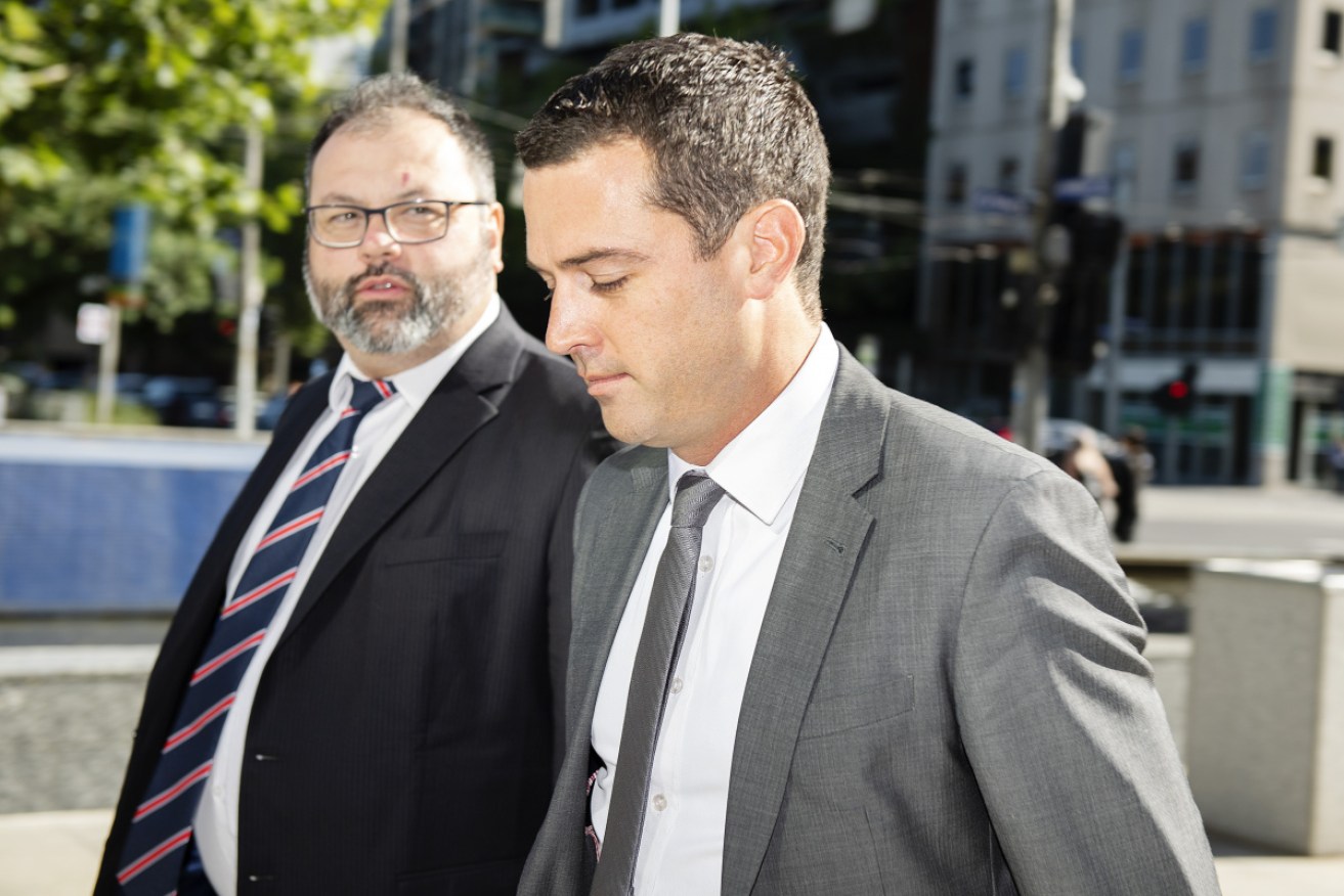 Michaelia Cash's former media adviser David De Garis (right) arrives at court in Melbourne on Monday.