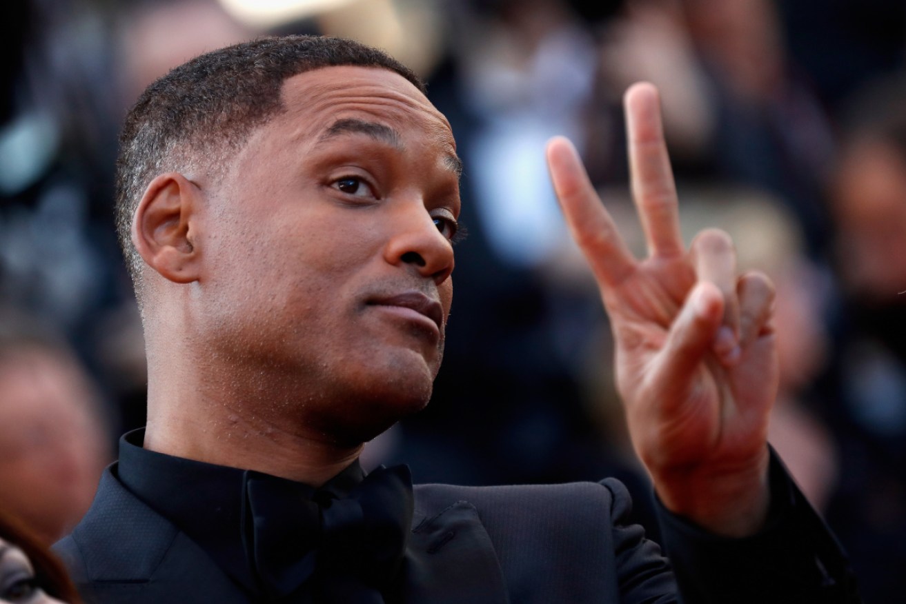 Will Smith flashes a sign to fans at the 2017 Cannes Film Festival.