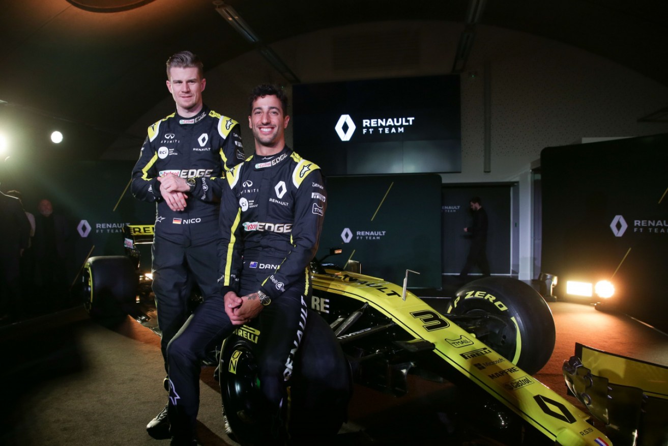 Renault's German driver Nico Hulkenberg (L) and Australian driver Daniel Ricciardo (R) pose with the Renault Sport F1 RS19. 